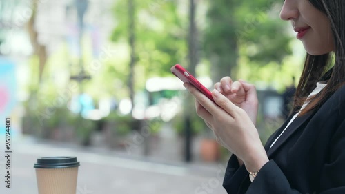 Wallpaper Mural A woman looking at her smartphone on a street corner Torontodigital.ca