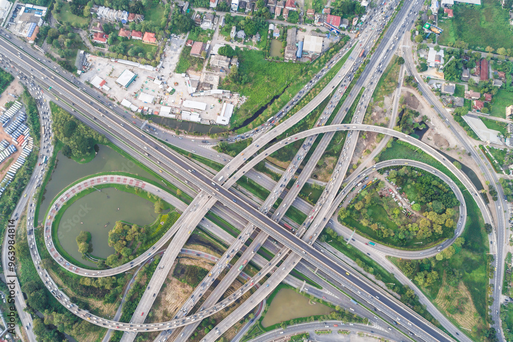 Naklejka premium Aerial view transport junction road with green tree park car movement sunset light
