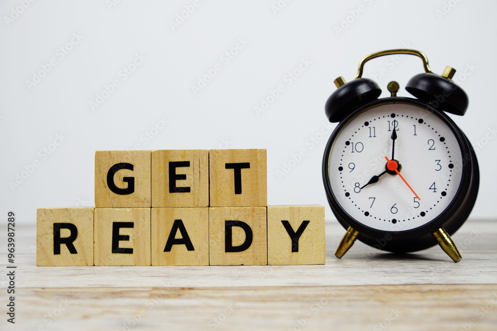 Time to Get Ready with wooden blocks alphabet letters and alarm clock on wooden background Time to Get Ready with wooden blocks alphabet letters and alarm clock on wooden background