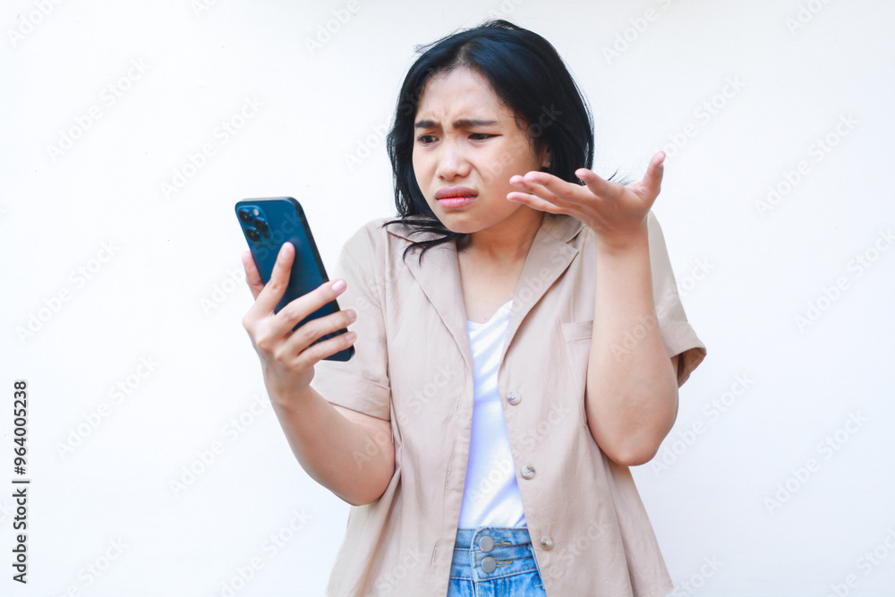 confused asian woman using smartphone with raised palms show uncertainty gesture wearing casual clothes isolated on white background confused asian woman using smartphone with raised palms show uncertainty gesture wearing casual clothes isolated on white background