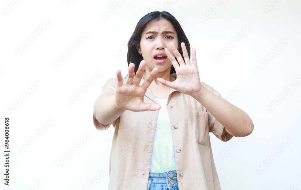 shocked asian woman covering her mouth wearing casual brown clothes isolated on white background