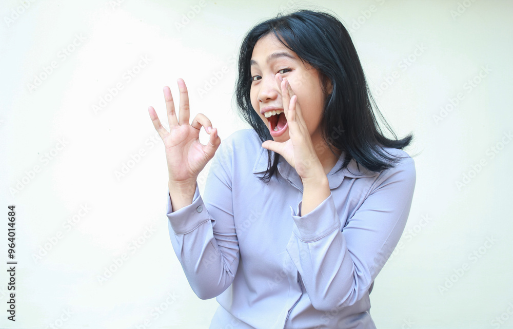 image of satissfied asian young business woman screaming to camera with open mouth giving ok sign with excitement wear formal purple shirt standing over isolated white background image of satissfied asian young business woman screaming to camera with open mouth giving ok sign with excitement wear formal purple shirt standing over isolated white background