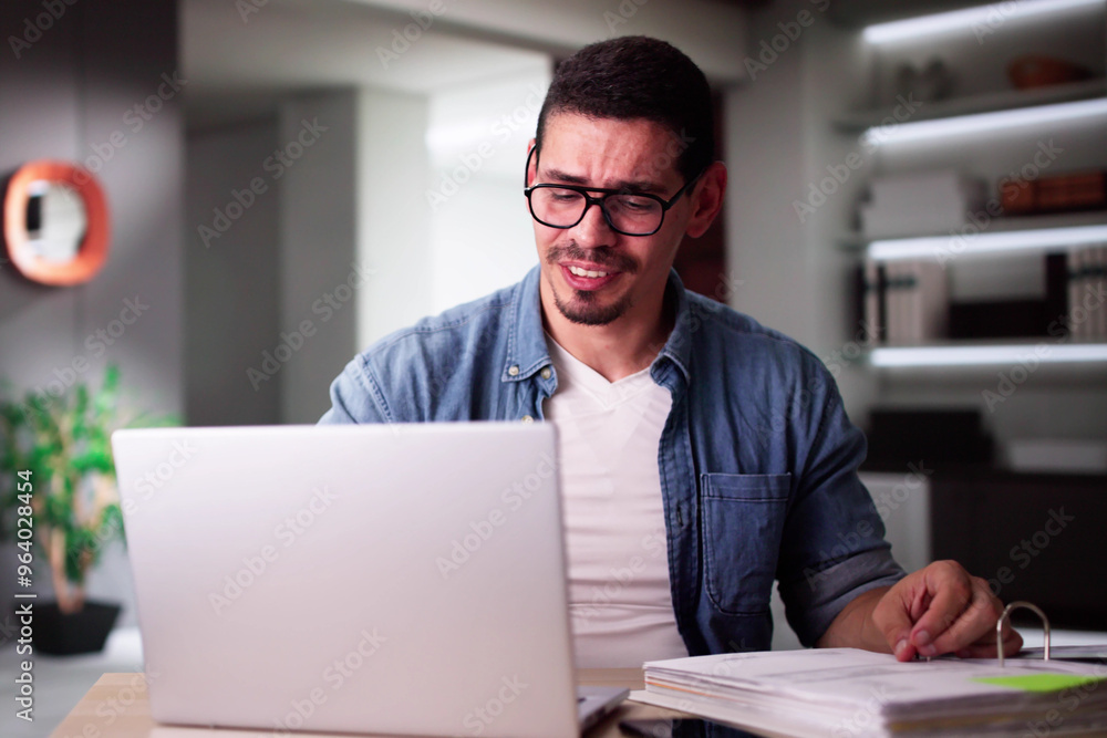 Young Man Suffering From Headache With Invoice Young Man Suffering From Headache With Invoice