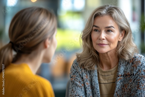 Wallpaper Mural Mentorship and Personal Growth: Senior Woman Mentoring Young Colleague in Career Development Meeting Torontodigital.ca