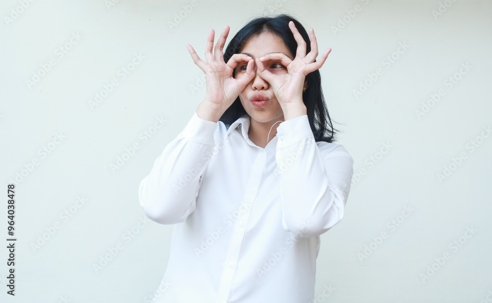 happy satisfied young asian woman showing ok signs on eyes wearing white formal suit shirt feeling proud looking away, okay symbols, standing over isolated background happy satisfied young asian woman showing ok signs on eyes wearing white formal suit shirt feeling proud looking away, okay symbols, standing over isolated background