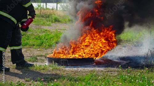 Wallpaper Mural Firefighter practice emergency response techniques as they tackle blaze from burning container. Thick smoke fills air as he works to control flames. Slow motion in 4K, UHD Torontodigital.ca