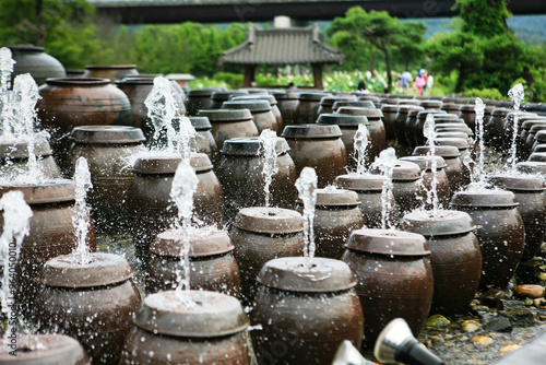 View of the fountains in the shape of the traditional Korean ceramic container, spraying water  photo