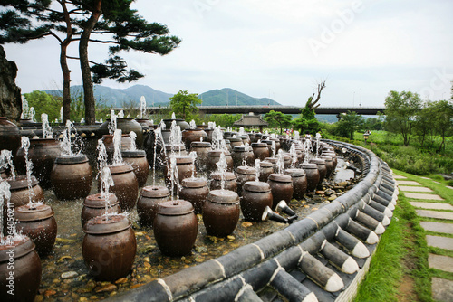 View of the fountains in the shape of the traditional Korean ceramic container, spraying water  photo