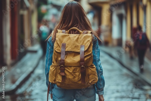 Woman walking with a large backpack. This photo is perfect for travel blogs, adventure stories, or any project related to exploration and wanderlust. photo