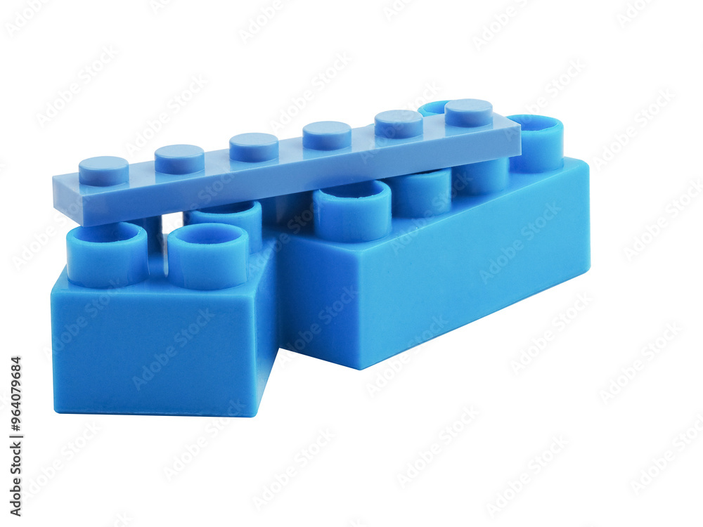 Fototapeta premium Blue Plastic Block on a White Background. Children Toy Brick, Perspective View. Close Up View of a Game Block for Constructors.