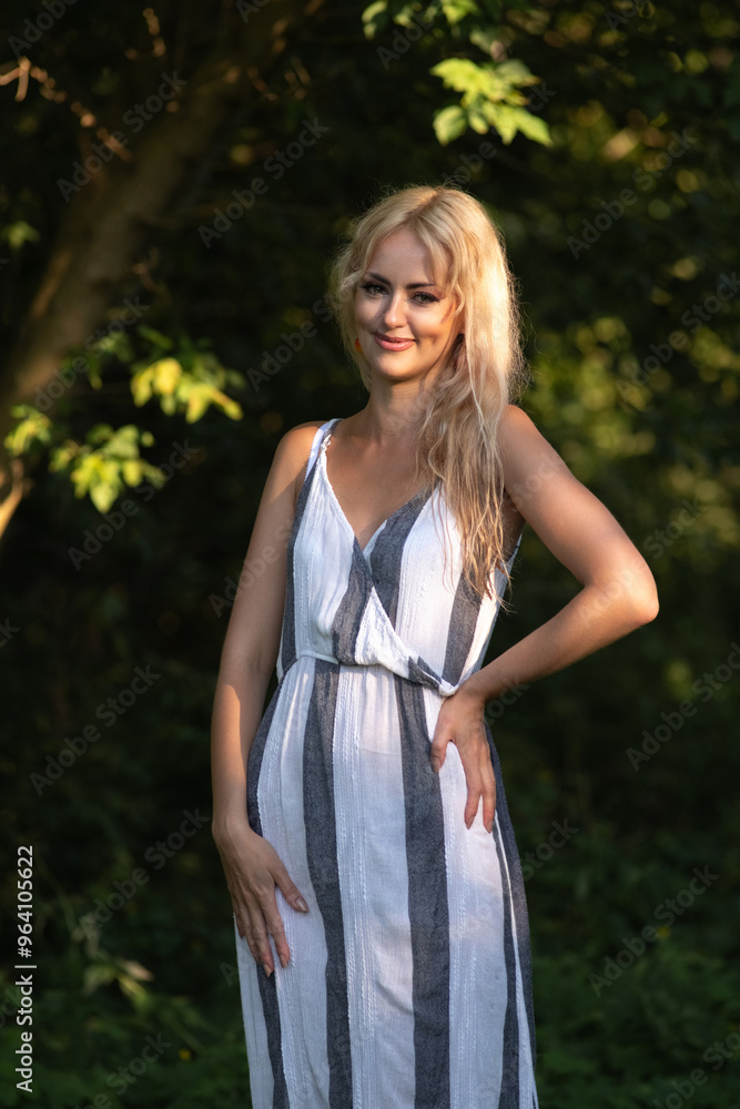 Portrait of a young beautiful blonde girl in a summer forest. Portrait of a young beautiful blonde girl in a summer forest.