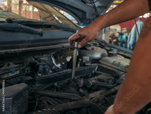 Close up Man hands fixing Car machinery vehicle mechanical service. Mechanic man hands repairing car auto repair shop. open vehicle hood checking up auto mobile. Vehicle Car maintenance engineer.