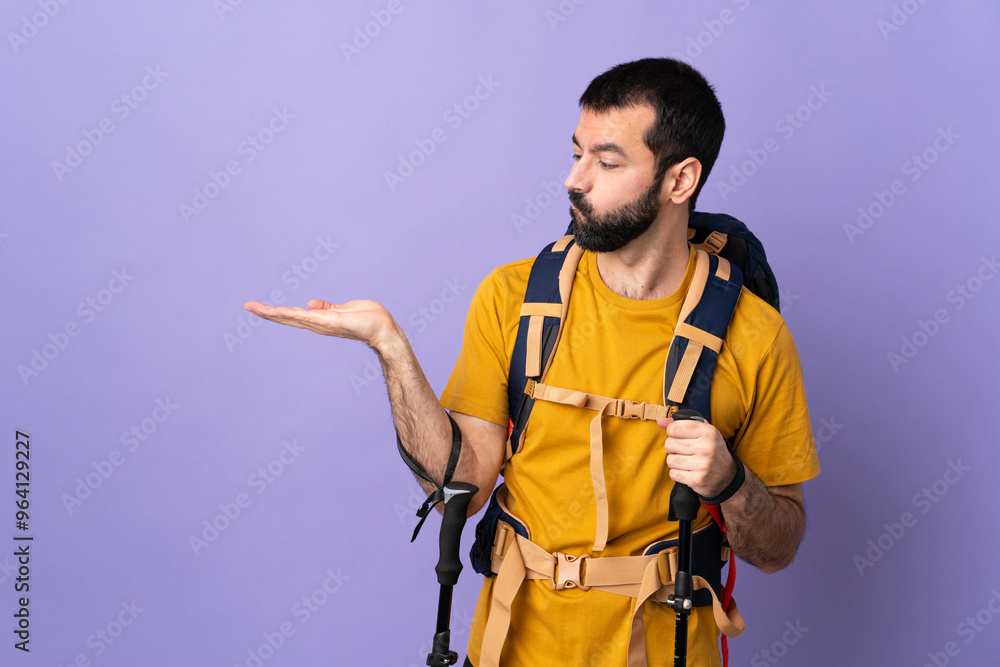 Caucasian handsome man with backpack and trekking poles over isolated background holding copyspace with doubts Caucasian handsome man with backpack and trekking poles over isolated background holding copyspace with doubts