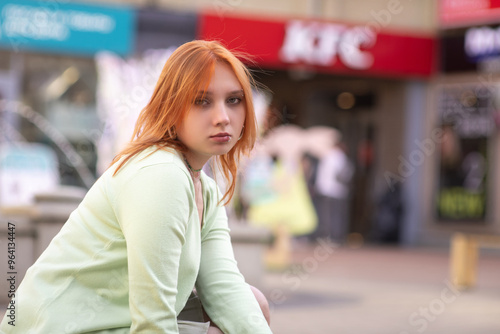 Portrait of a young beautiful blonde girl in an urban environment.