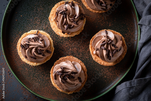 Homemade mini tartlets made of shavings and cream. photo