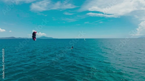 Kitesurfing in the ocean on a sunny day