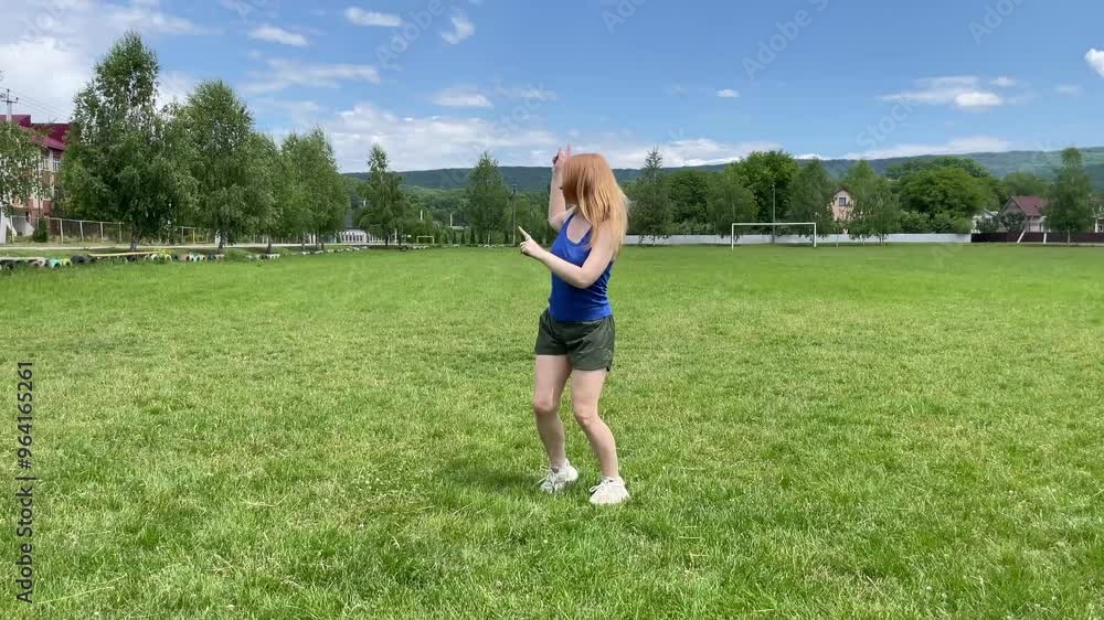 Young woman practicing a modern jazz dance routine on a sunny grassy field, showcasing energy and passion in her movements Young woman practicing a modern jazz dance routine on a sunny grassy field, showcasing energy and passion in her movements