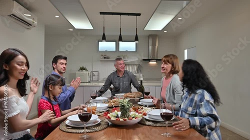 Big family with multi-ethnic came to meet and greet preparing food for celebration wedding anniversary party together in dining room at home
