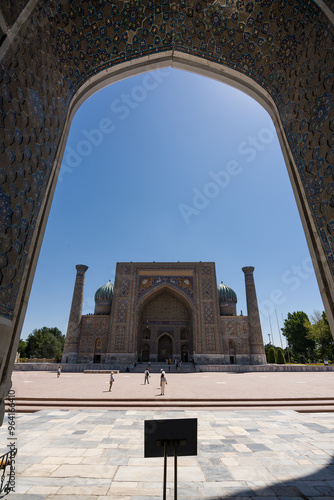 Facade of Sher-Dor Madrasah seen from inside the front portal in Registan Square in Samarkand photo