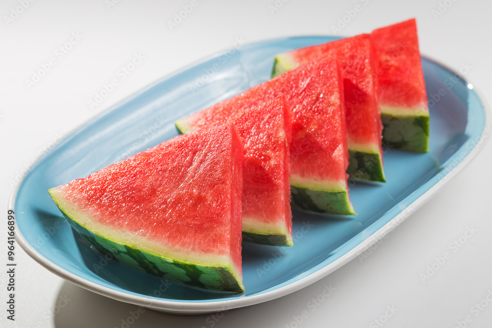 Watermelon with a triangle shape placed on a ceramic tray, Watermelon with a triangle shape placed on a ceramic tray,