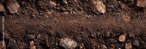 Closeup view of rugged soil surface that is scattered with various rocks and natural debris elements