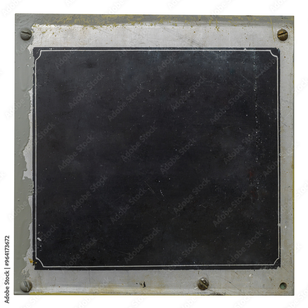 Fototapeta premium Copy space on an old worn metal black industrial nameplate is isolated.