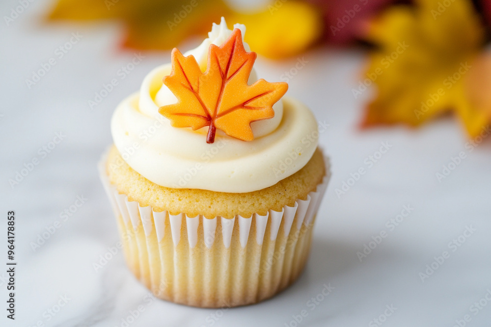 Delightful cupcake topped with maple leaf design, perfect for autumn celebrations.