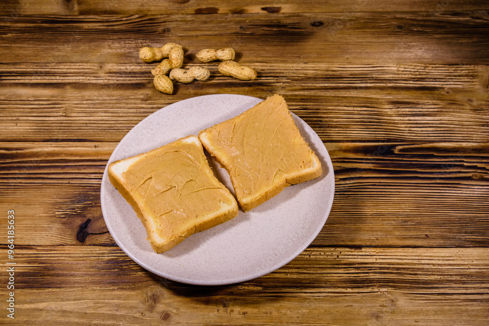Sandwiches with peanut butter in plate on a wooden table