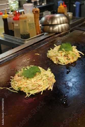 Okonomiyaki, JapanesePancake, SavoryPancake, JapaneseCuisine, StreetFood, Teppanyaki, JapaneseComfortFood, TraditionalJapaneseFood, GrilledDish, CabbagePancake, AsianCuisine, CustomizableDish, Japanes
