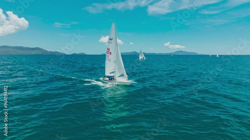 Sailors are having fun using a small sailboat at sea
