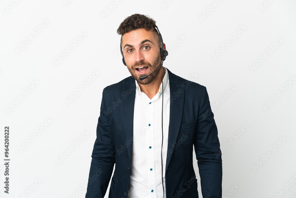 Telemarketer man working with a headset isolated on white background with surprise facial expression Telemarketer man working with a headset isolated on white background with surprise facial expression