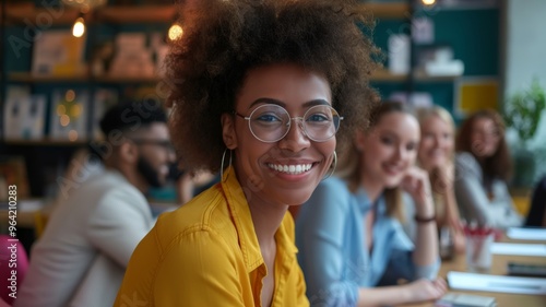 Positive young woman smiling while working in a creative team environment