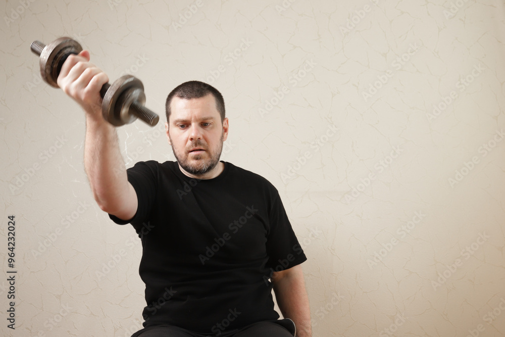 Man exercising in home gym, practicing strength training with dumbbells, enhancing his muscular body with effort and motivation. Man exercising in home gym, practicing strength training with dumbbells, enhancing his muscular body with effort and motivation.