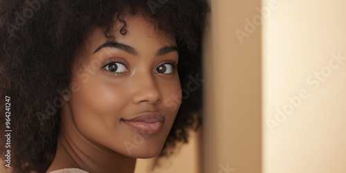 A woman with dark hair and a big smile. She is looking at the camera. Concept of happiness and confidence