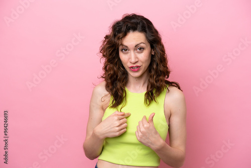 Young caucasian woman isolated on pink background pointing to oneself