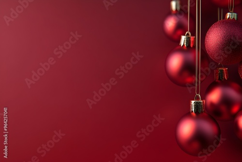 A red background with a bunch of red Christmas ornaments hanging from it