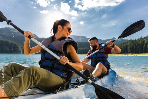 Couple Enjoying a Kayaking Adventure on a Mountain Lake