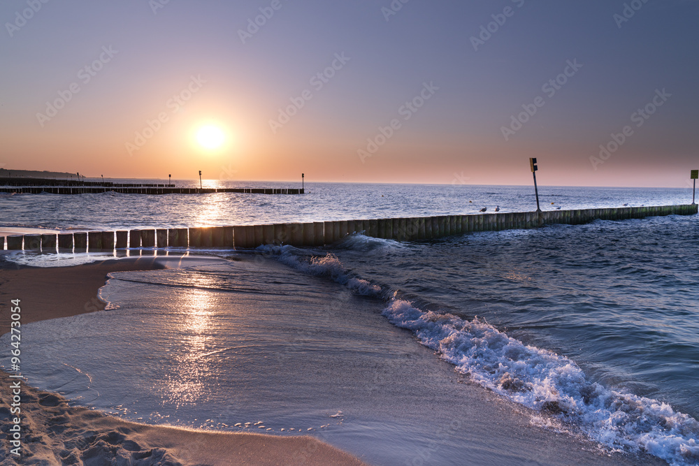 Fototapeta premium Serene sunset at the shoreline in Kolobrzeg, Kołobrzeg