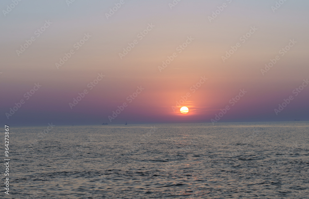 Fototapeta premium Serene sunset at the shoreline in Kolobrzeg, Kołobrzeg