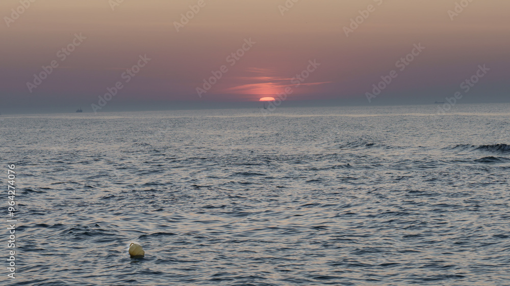 Serene sunset at the shoreline in Kolobrzeg, Kołobrzeg Serene sunset at the shoreline in Kolobrzeg, Kołobrzeg