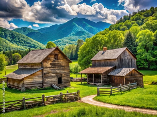 Rustic historic farmhouse and outbuildings surrounded by lush green pastures and majestic mountain vistas at a rural heritage museum in Cherokee, North Carolina.