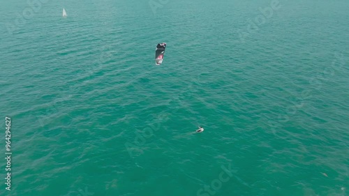 Kitesurfing in the ocean on a sunny day. Kite surfers having fun in the ocean