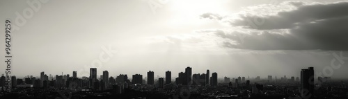 Breathtaking black and white cityscape with dramatic clouds and sunrays illuminating tall buildings and skyline under a moody sky.