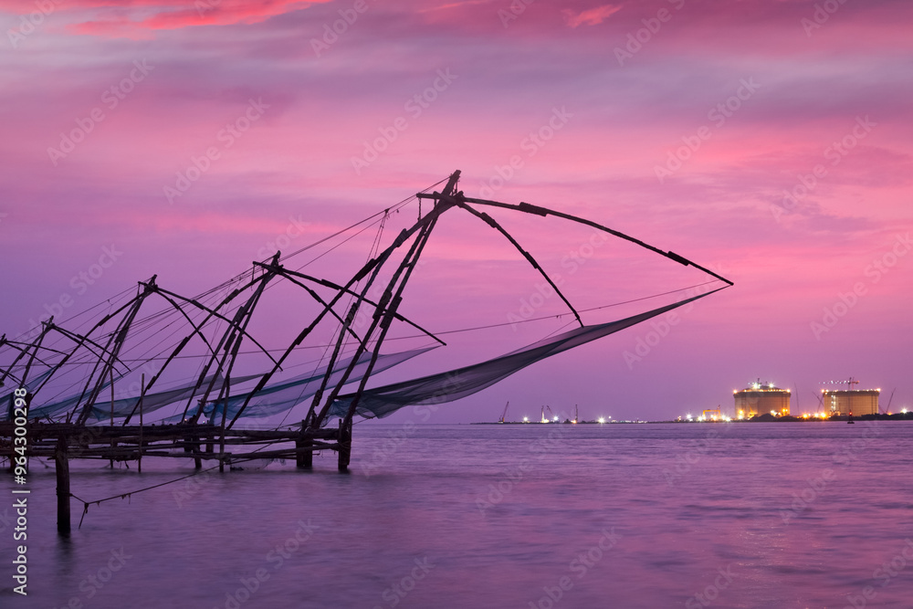 Fototapeta premium Kochi Chinese fishnets on sunset. Fort Kochin, Kochi, Kerala, India