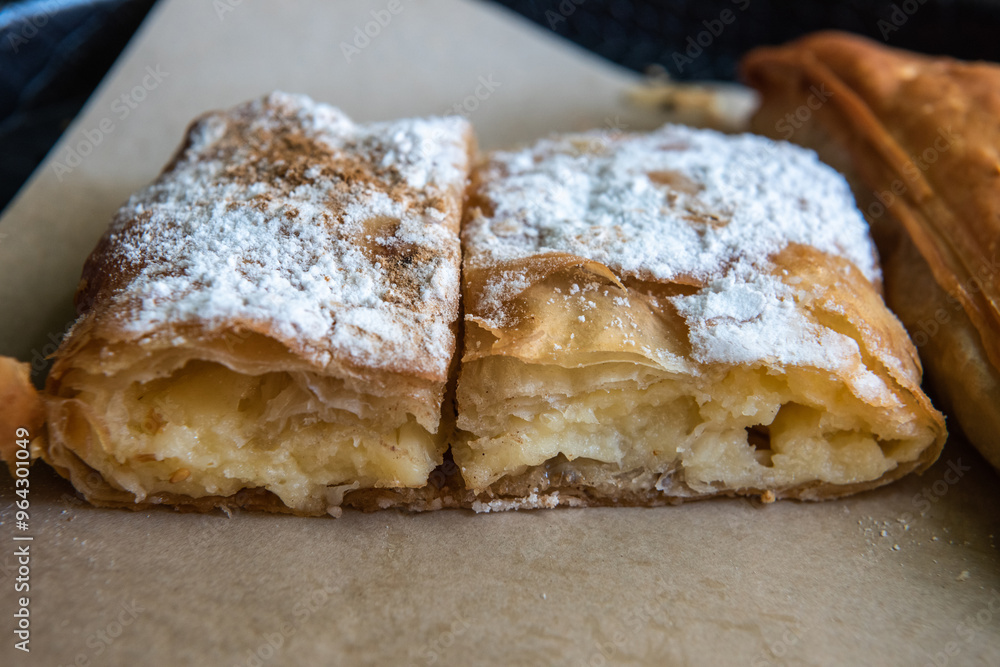 Bougatsa, a traditional Greek breakfast food. Bougatsa has several versions with their own filling, with the most popular the bougatsa krema (bougatsa cream) Bougatsa, a traditional Greek breakfast food. Bougatsa has several versions with their own filling, with the most popular the bougatsa krema (bougatsa cream)