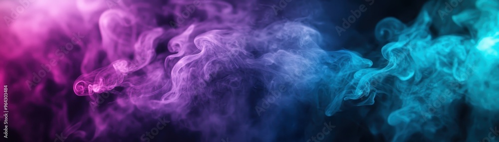 Fototapeta premium Colorful smoke abstract background with vibrant pink and blue wisps merging in dark space, perfect for creative designs and visual effects.