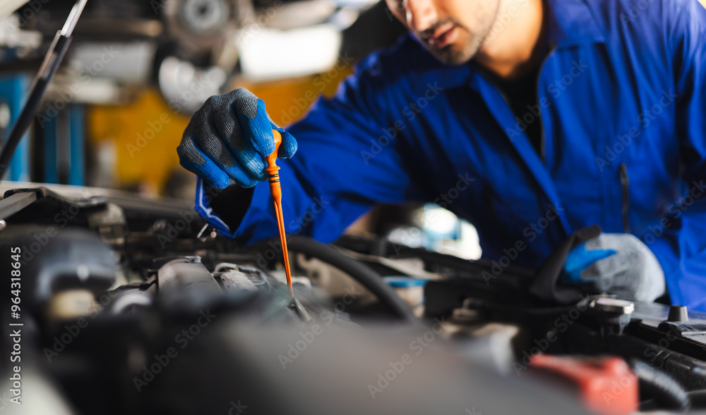 Close up hand hispanic latin male mechanic repairs car in garage. Closeup hand. Auto car mechanic checking the oil level of the car engine. Car repair and maintenance Close up hand hispanic latin male mechanic repairs car in garage. Closeup hand. Auto car mechanic checking the oil level of the car engine. Car repair and maintenance
