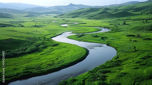 An aerial view of a river winding through a green valley.