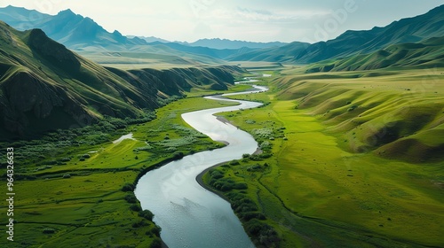 An aerial view of a river winding through a green valley.