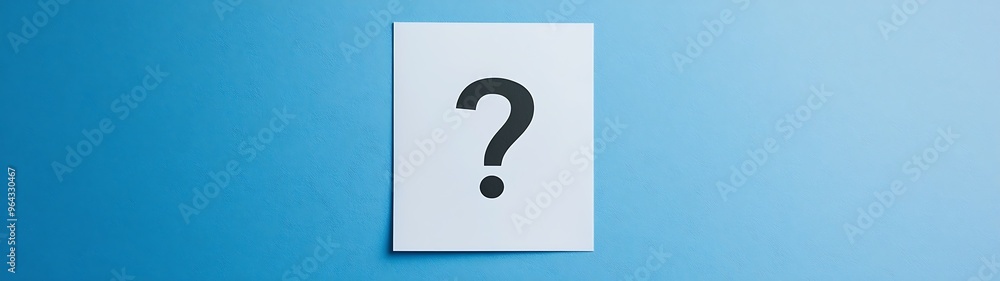 Curiosity Unveiled: Question Mark on White Paper Against Blue Background for Educational and Information Designs Curiosity Unveiled: Question Mark on White Paper Against Blue Background for Educational and Information Designs